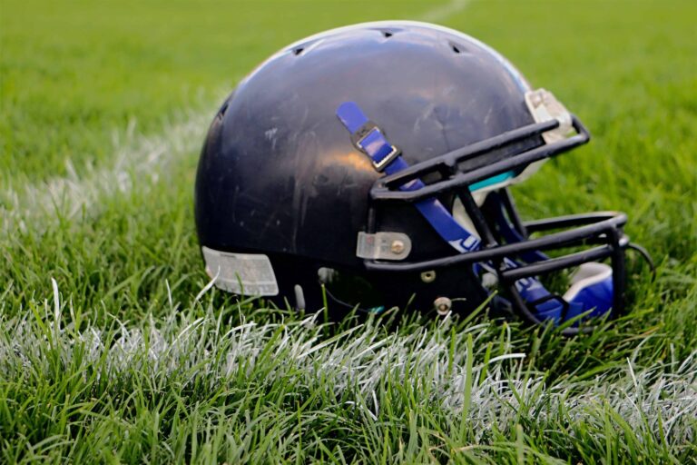 football-helmet-resting-on-football-field-yard