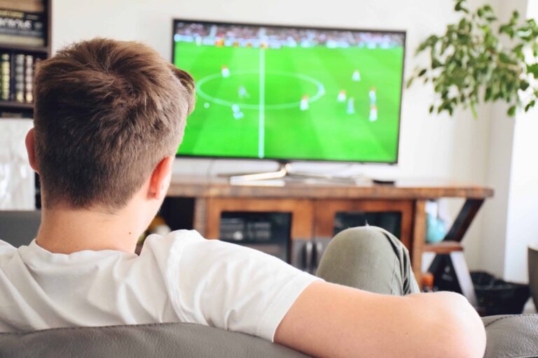 young-man-watching-soccer-game-on-tv-football-game